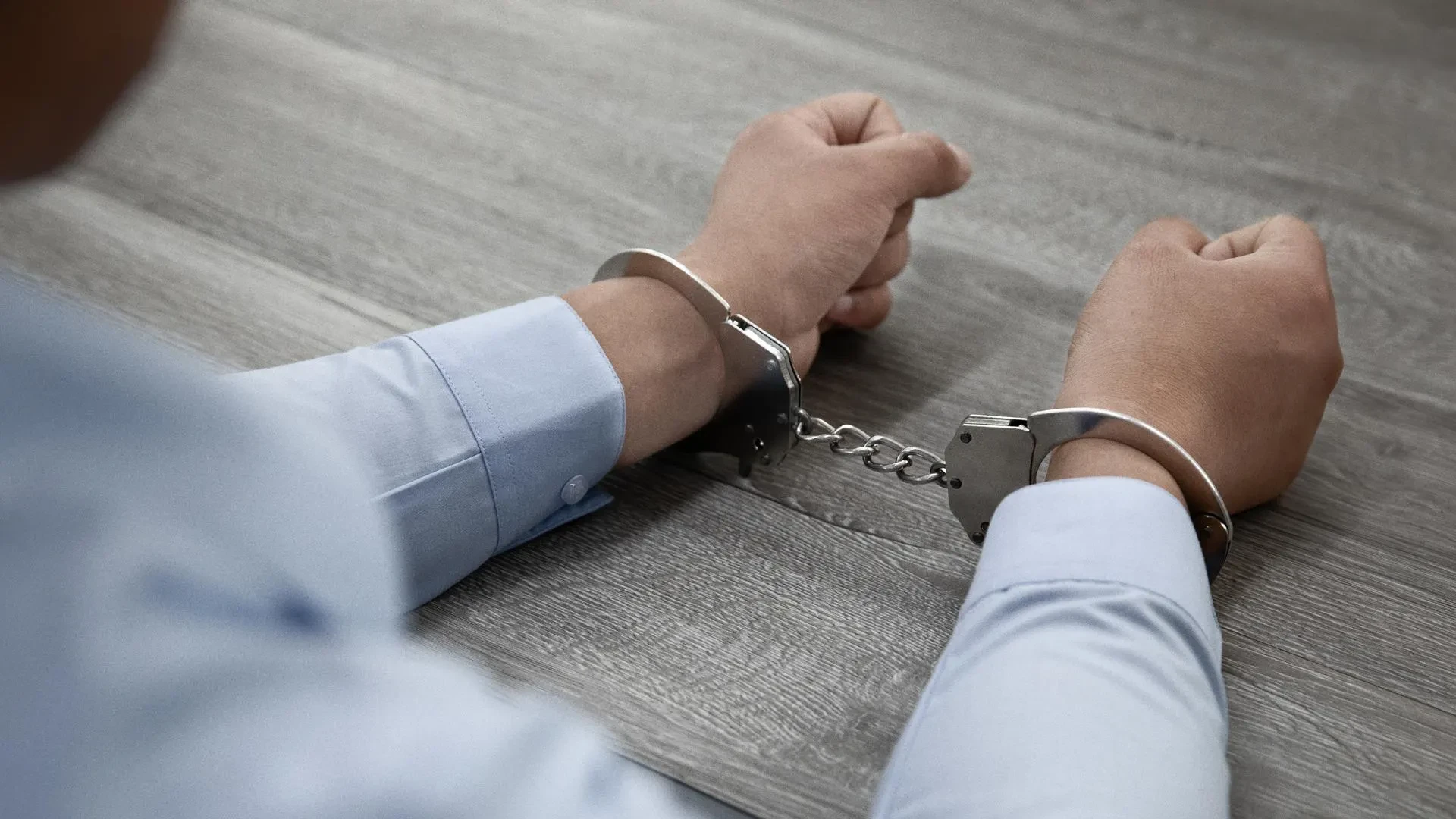 Criminal in handcuffs for harming.