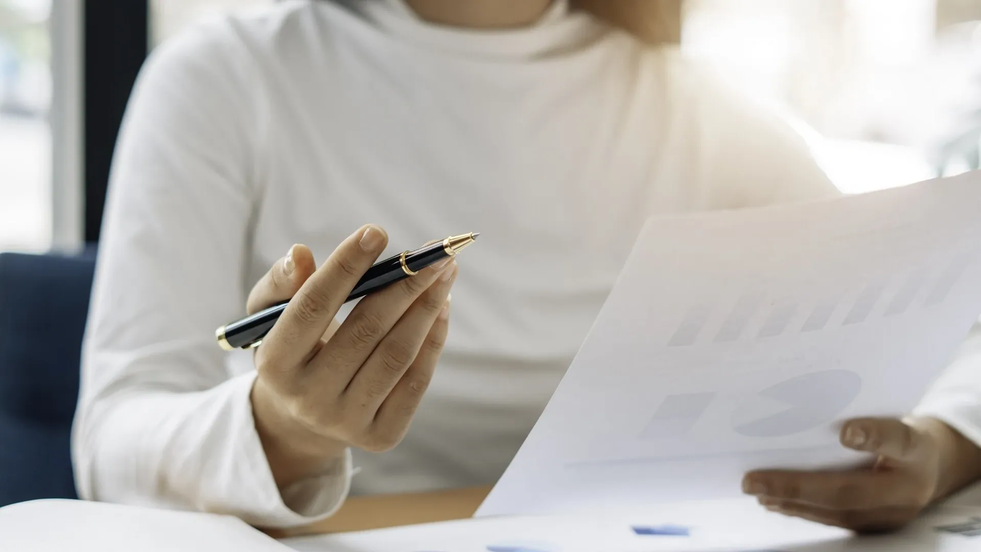 Closeup shot of a solicitor looking at company documents to help build a claim.